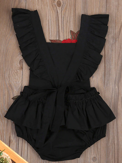 Baby little onesie has big red flower appliques and ties at the back for easy slip-on  black