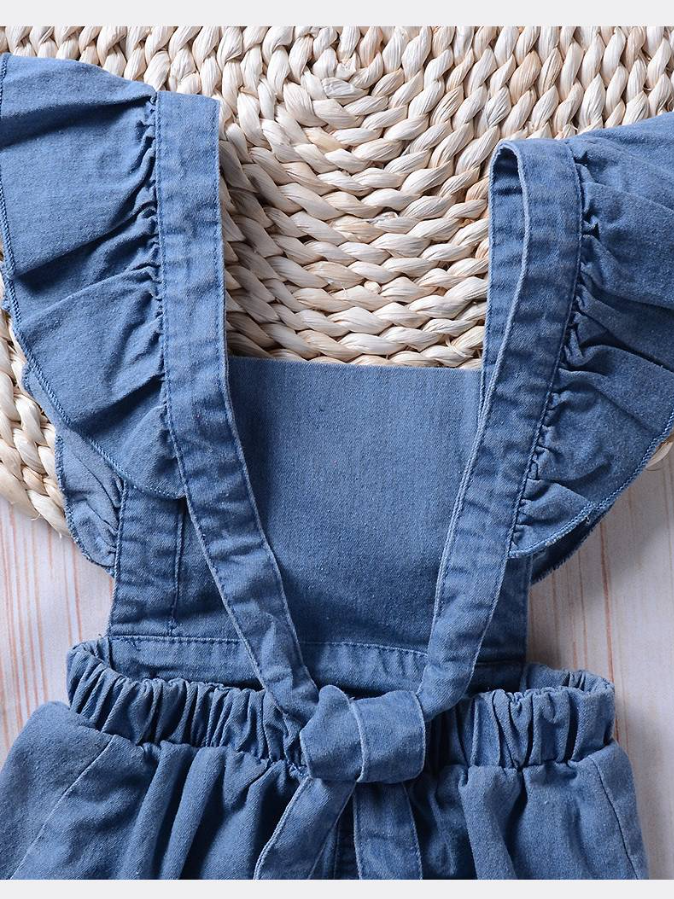 Baby overall style romper onesie has ruffled shoulder straps that tie on the back. has 2 little buttons on the front to make it even more stylish