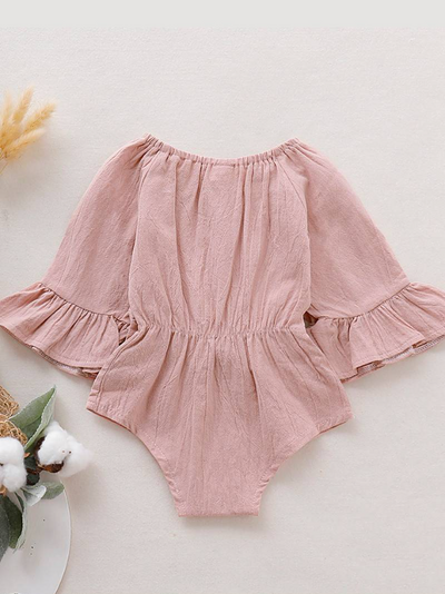 Baby boho style onesie has ruffled long sleeves and a cute bow at the front