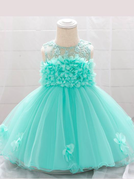 The dress has a bodice with flower applique and tulle skirt