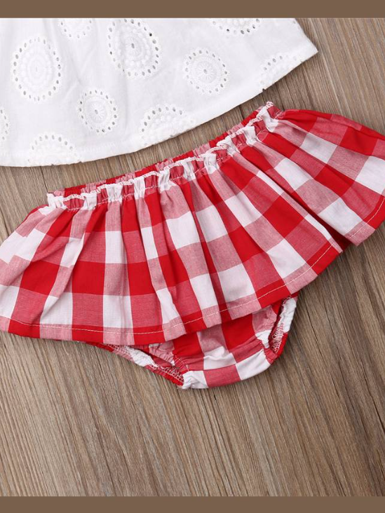 Baby set features an eyelet off-shoulder top and checkered skirted bloomers with a headband