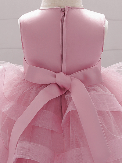 Baby princess dress has a satin bodice with sequin applique, a bow belt at the waist, and a layered tulle skirt