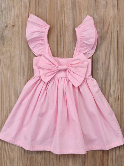 Baby apron style dress has a ruffled adjustable straps and a stretchy bodice with a big bow