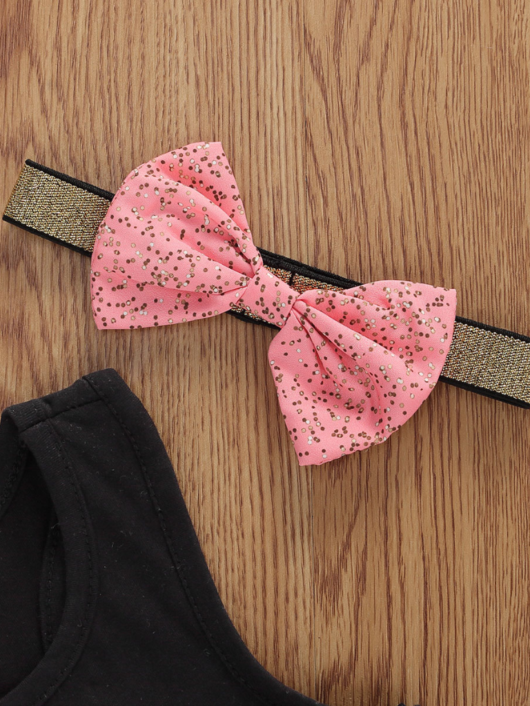 Baby set features a black top with a gold "One" print and a pink tutu skirt with a sequin bow at the waist. Comes with a matching sequin headband