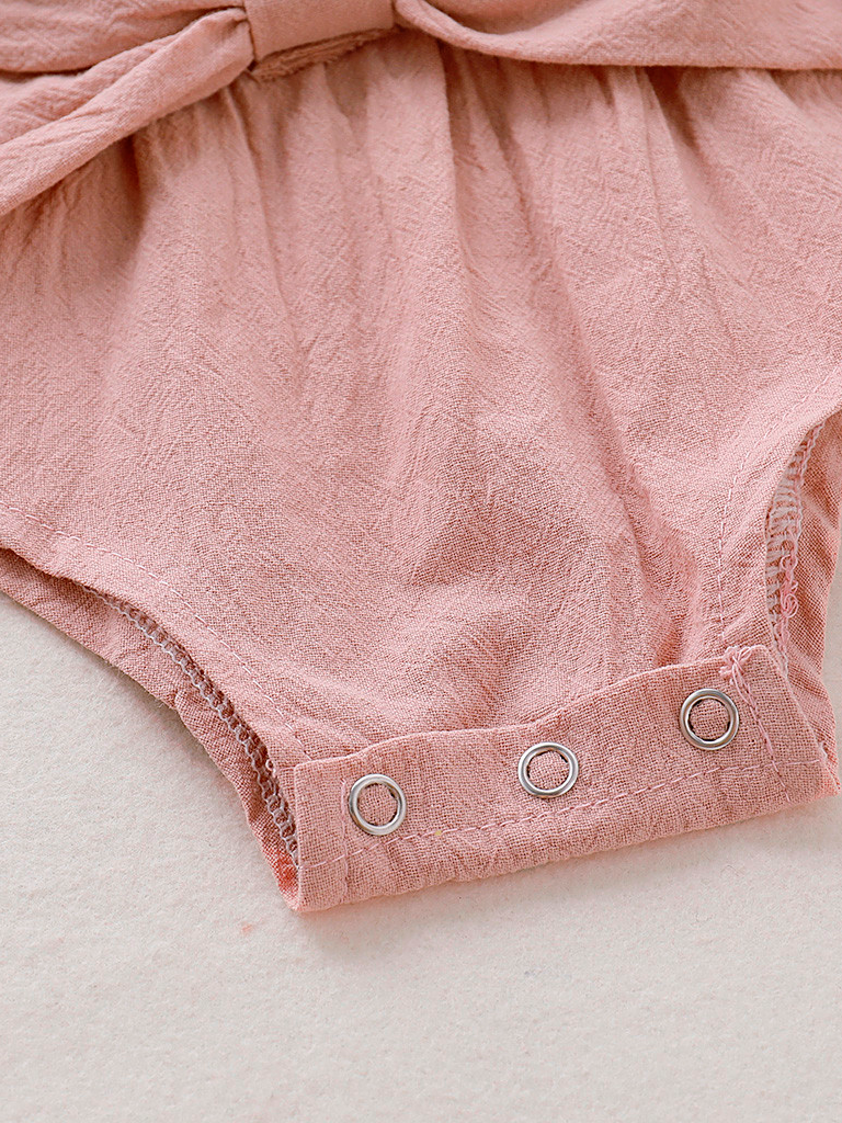 Baby boho style onesie has ruffled long sleeves and a cute bow at the front