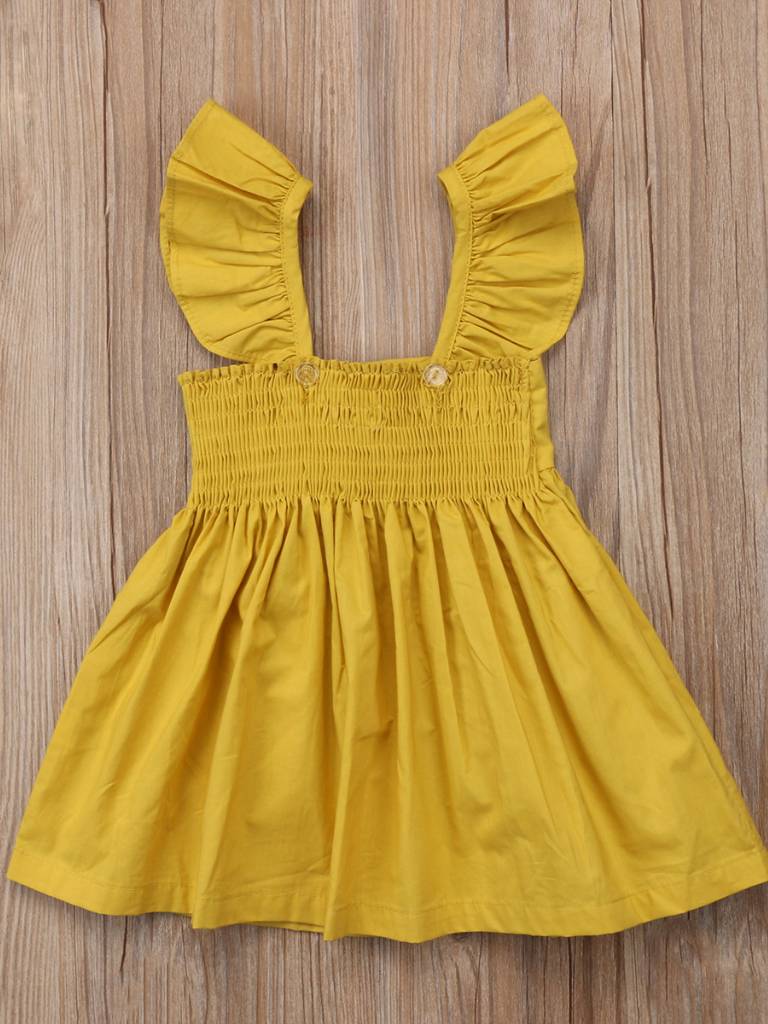 Baby apron style dress has a ruffled adjustable straps and a stretchy bodice with a big bow