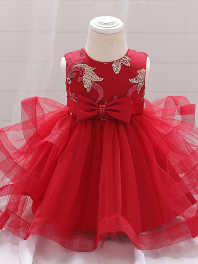 Baby princess dress has a satin bodice with sequin applique, a bow belt at the waist, and a layered tulle skirt