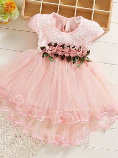 Baby Spring dress has an embroidered bodice, applique flowers at the waistline, and a hi-lo tulle skirt