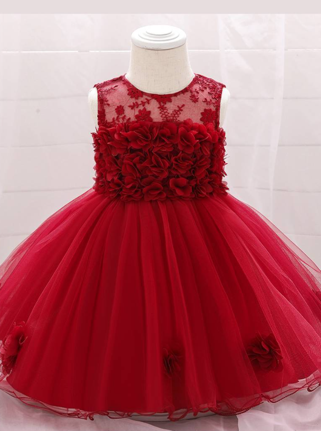 The dress has a bodice with flower applique and tulle skirt