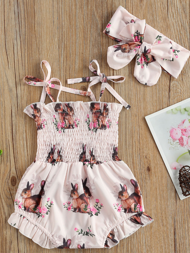 Baby pink onesie with bunny prints and a stretchy bodice with adjustable shoulder straps with a matching headband