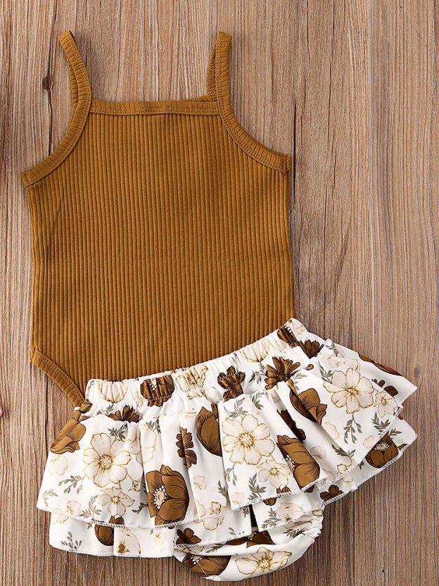 Baby onesie bodysuit has a cute ruffle detail and front buttons and spaghetti straps and skirted bloomers