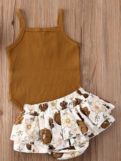 Baby onesie bodysuit has a cute ruffle detail and front buttons and spaghetti straps and skirted bloomers