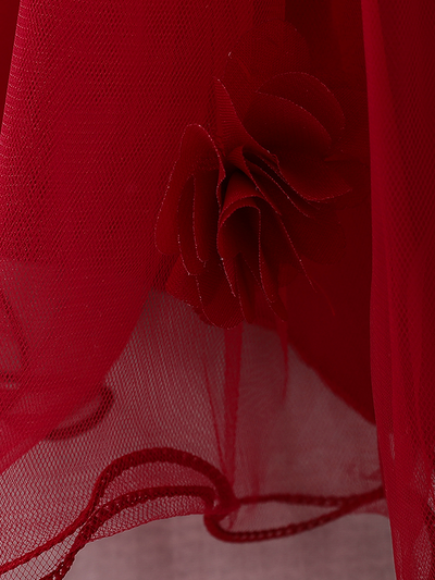 The dress has a bodice with flower applique and tulle skirt