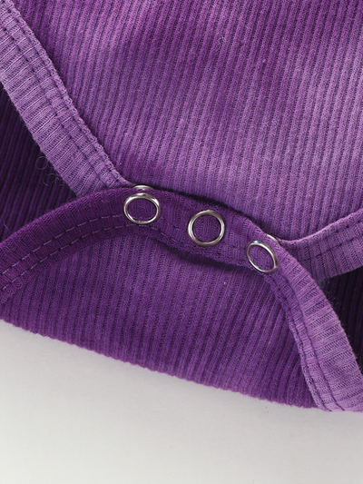 Baby set features a tie-dye long-sleeved onesie with ruffled shoulders, ruffled leggings, and matching headbands