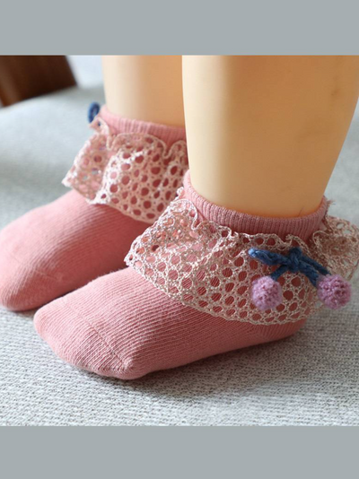 Baby socks with crochet and pompom details