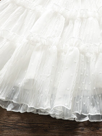 Baby swiss tulle dress has delicate ruffles and a little bow at the front