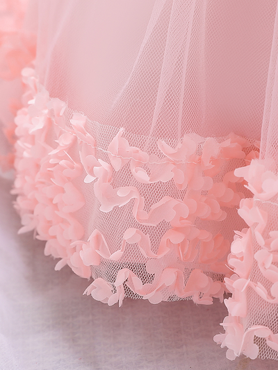 Baby dress has a floral bodice, a tulle skirt with floral hem, and a gold sequin belt with bow at the front and back