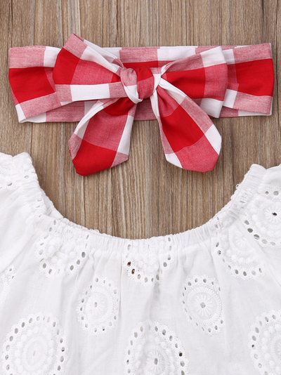 Baby set features an eyelet off-shoulder top and checkered skirted bloomers with a headband