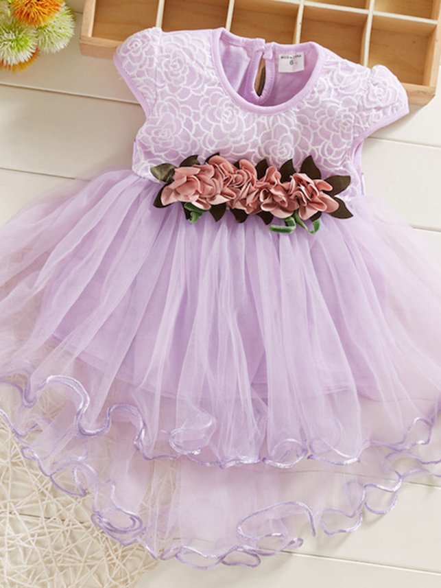 Baby Spring dress has an embroidered bodice, applique flowers at the waistline, and a hi-lo tulle skirt