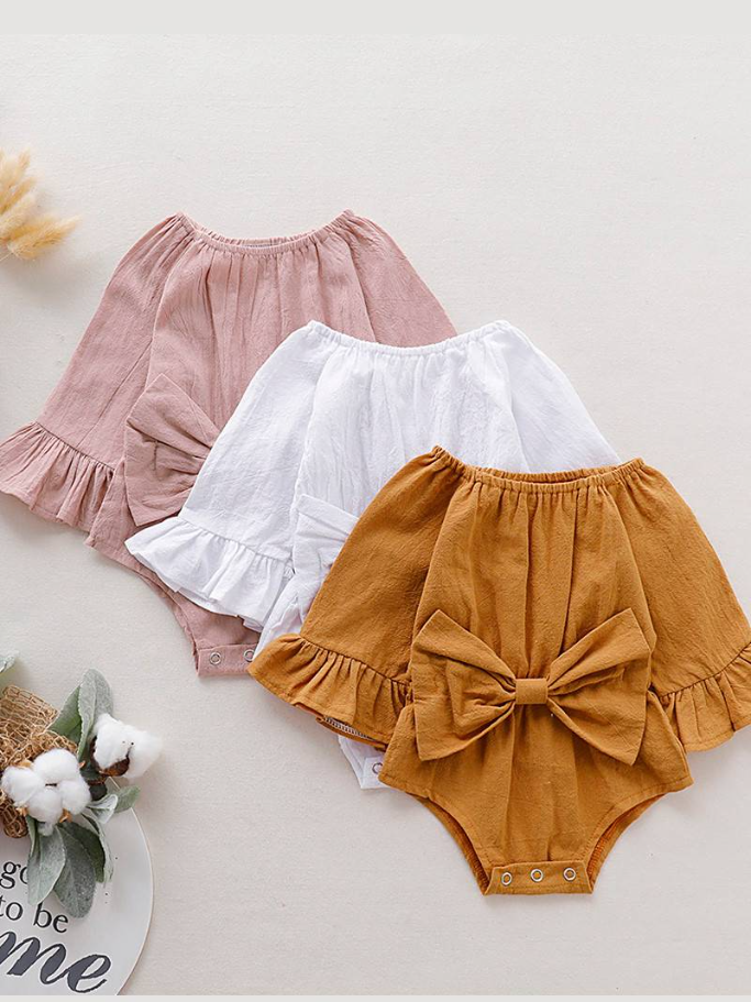 Baby boho style onesie has ruffled long sleeves and a cute bow at the front