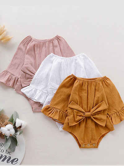 Baby boho style onesie has ruffled long sleeves and a cute bow at the front