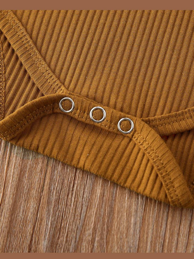 Baby onesie bodysuit has a cute ruffle detail and front buttons and spaghetti straps and skirted bloomers