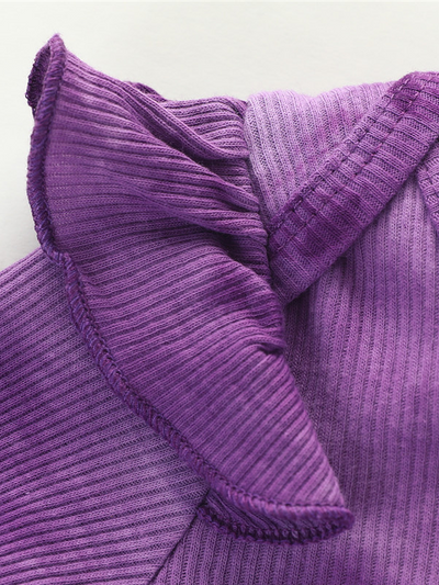 Baby set features a tie-dye long-sleeved onesie with ruffled shoulders, ruffled leggings, and matching headbands