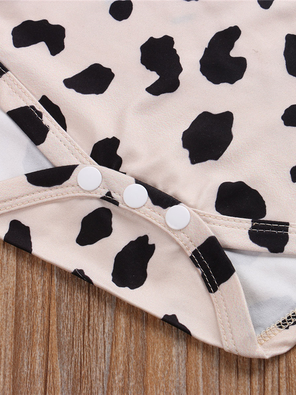 Baby set features a short-sleeved onesie with animal print, bloomer shorts with a bow, and matching headbands