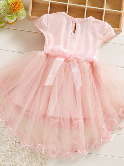 Baby Spring dress has an embroidered bodice, applique flowers at the waistline, and a hi-lo tulle skirt