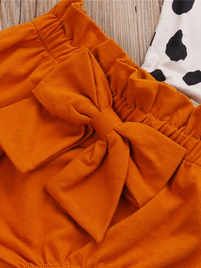 Baby set features a short-sleeved onesie with animal print, bloomer shorts with a bow, and matching headbands