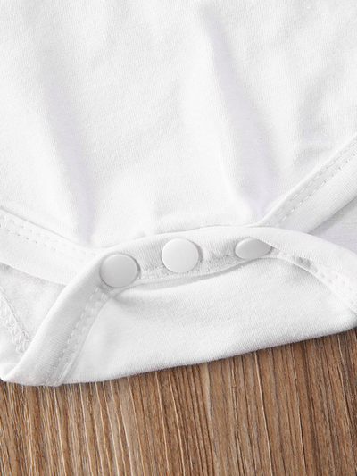 Baby set features a ruffled top with an " I got it from my Mama" print onesie and leopard skirted bloomers with a headband