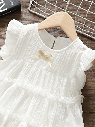 Baby swiss tulle dress has delicate ruffles and a little bow at the front