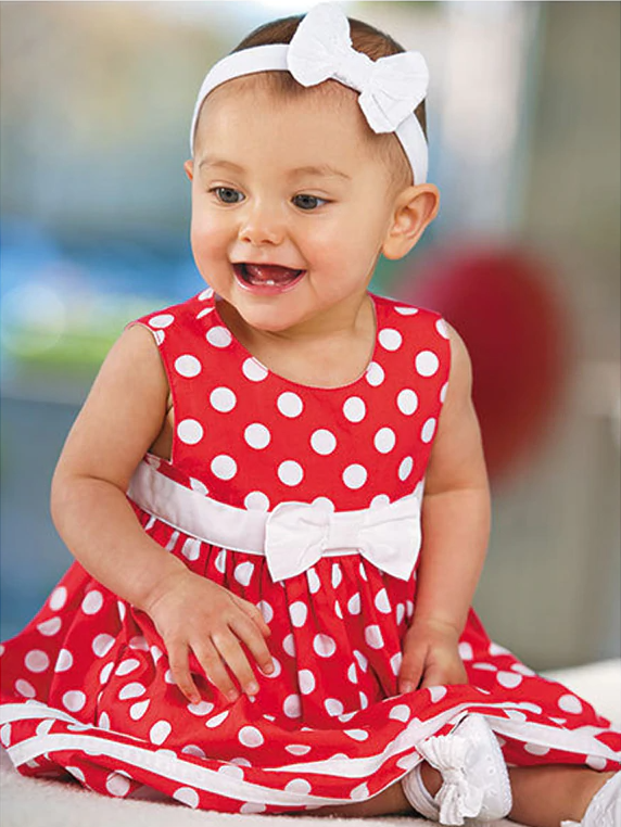 Baby red summer dress has a cute white polka dot print, a white bow at the waist and comes with matching bloomers