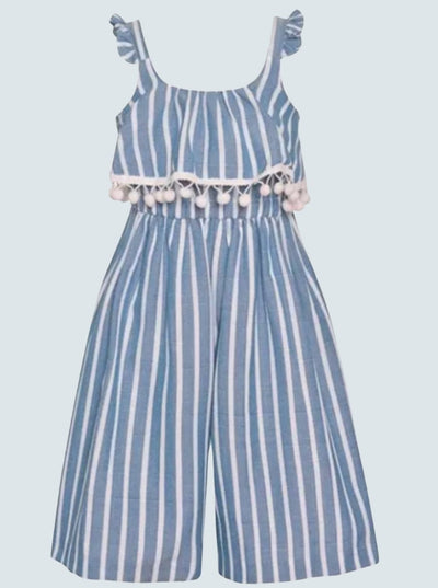 The striped jumpsuit features ruffle shoulders, a ruffle overlay with pom-pom trim, and palazzo style pant legs 