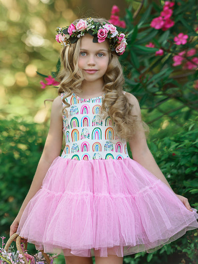 Girls dress has a white bodice with rainbow prints and a full pink tutu skirt
