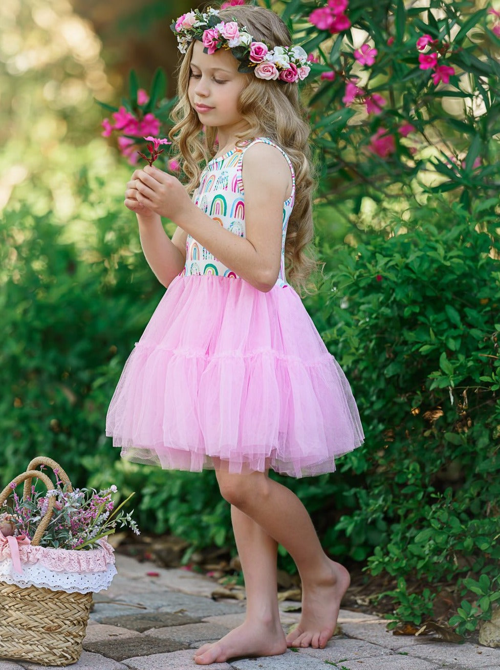 Girls dress has a white bodice with rainbow prints and a full pink tutu skirt