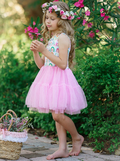 Girls dress has a white bodice with rainbow prints and a full pink tutu skirt