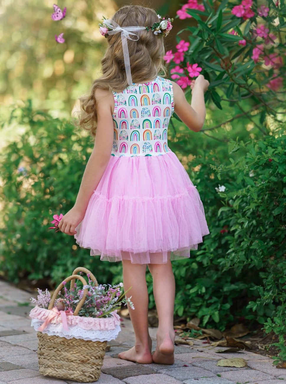 Girls dress has a white bodice with rainbow prints and a full pink tutu skirt