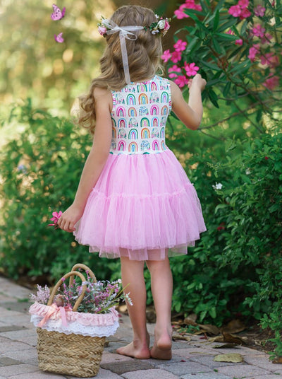 Girls dress has a white bodice with rainbow prints and a full pink tutu skirt