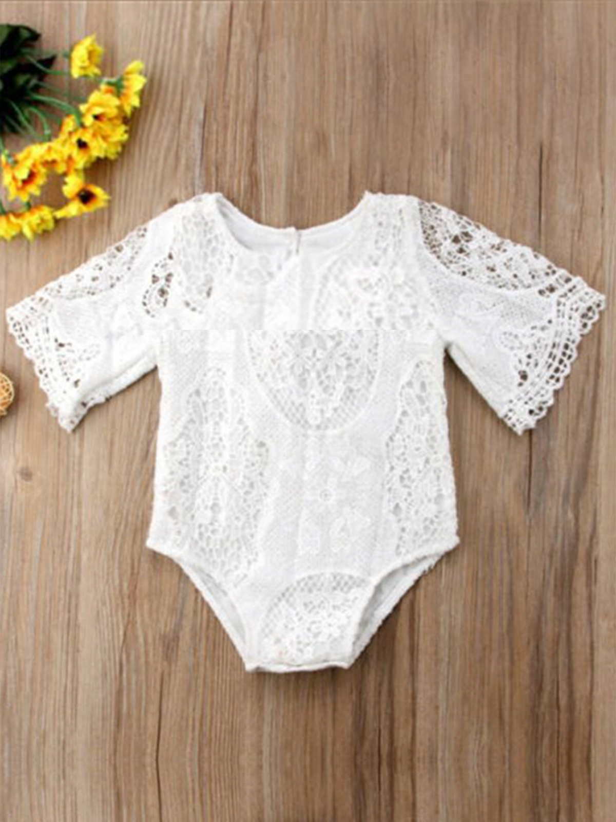Baby lace onesie has kimono style long sleeves