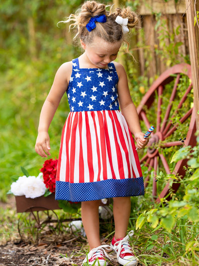 girls dress features a blue bodice with white stars, a red/white striped skirt, and a starred hem