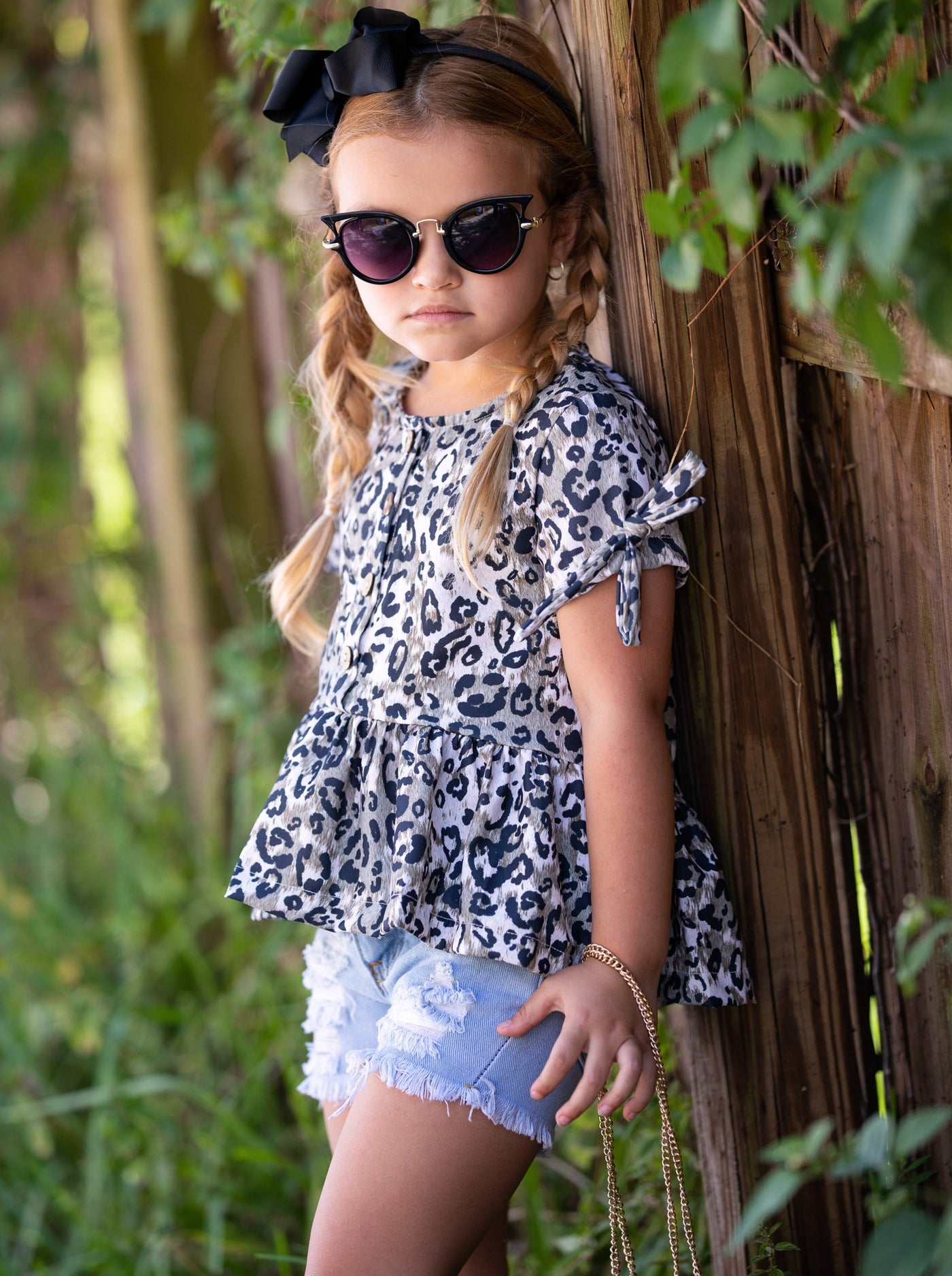 girls set features a leopard printed top with distressed denim shorts