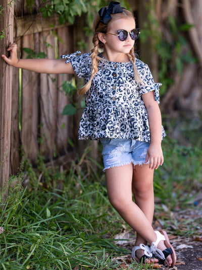 girls set features a leopard printed top with distressed denim shorts