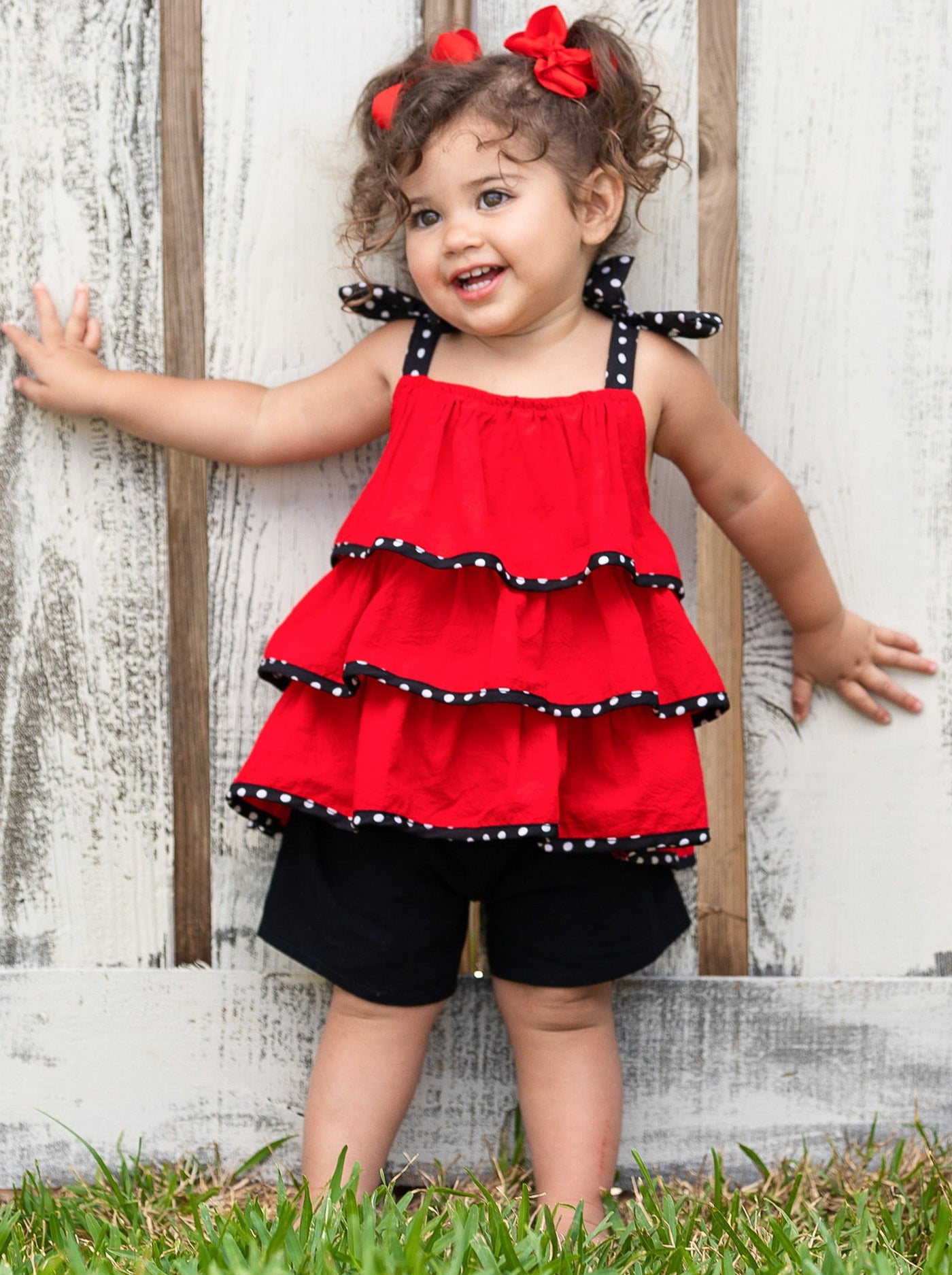 Girls set features a red top polka dot bow straps and three-tier ruffle hem and black shorts with stretchy waistband 2T -10Y