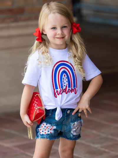 Girls set features a white top with "Freedom" print and patched denim shorts with a red sash