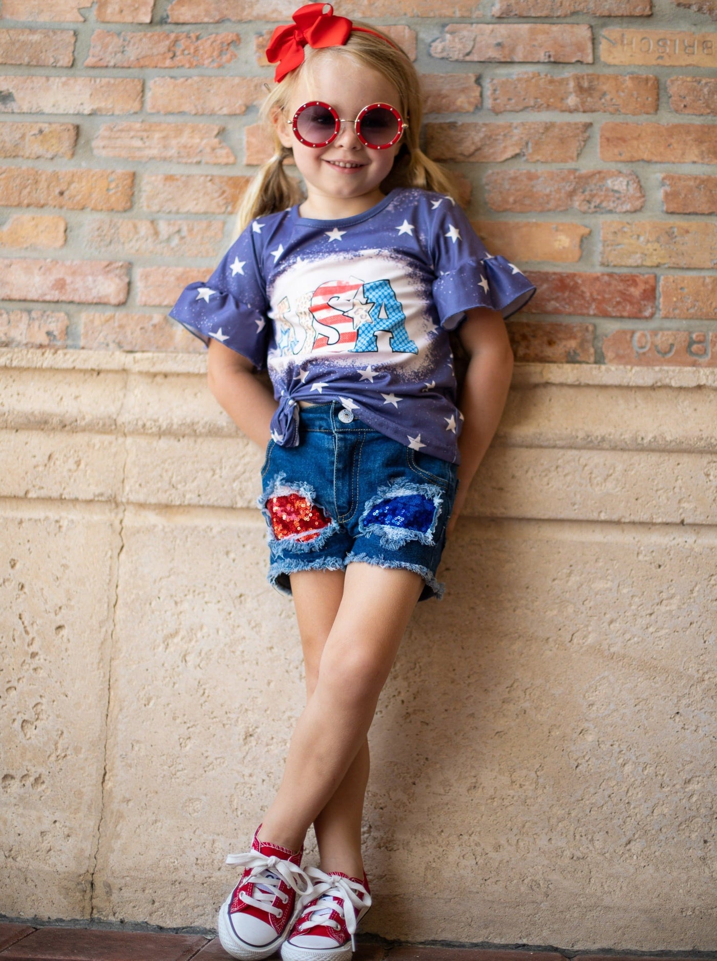 Girls set features a starred top with USA print and red/blue sequin patched denim shorts