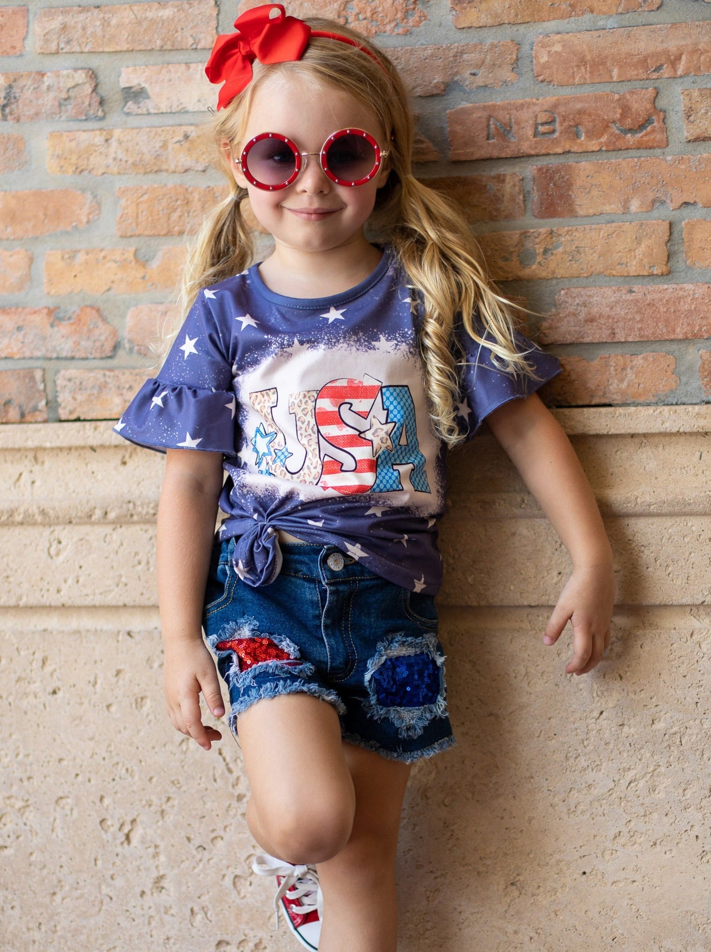 Girls set features a starred top with USA print and red/blue sequin patched denim shorts