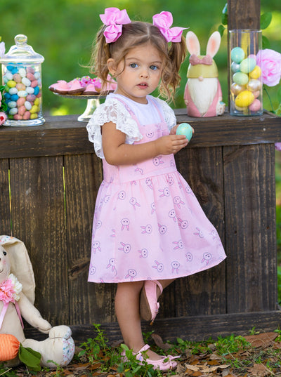 Girls Spring set features a white top with ruffle lace sleeves and an overall skirt with front kangaroo pocket and bunny print for toddlers and girls