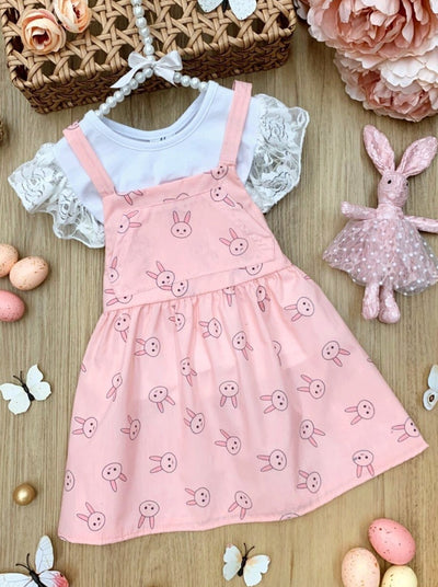 Girls Spring set features a white top with ruffle lace sleeves and an overall skirt with front kangaroo pocket and bunny print for toddlers and girls