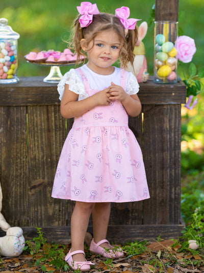 Girls Spring set features a white top with ruffle lace sleeves and an overall skirt with front kangaroo pocket and bunny print for toddlers and girls